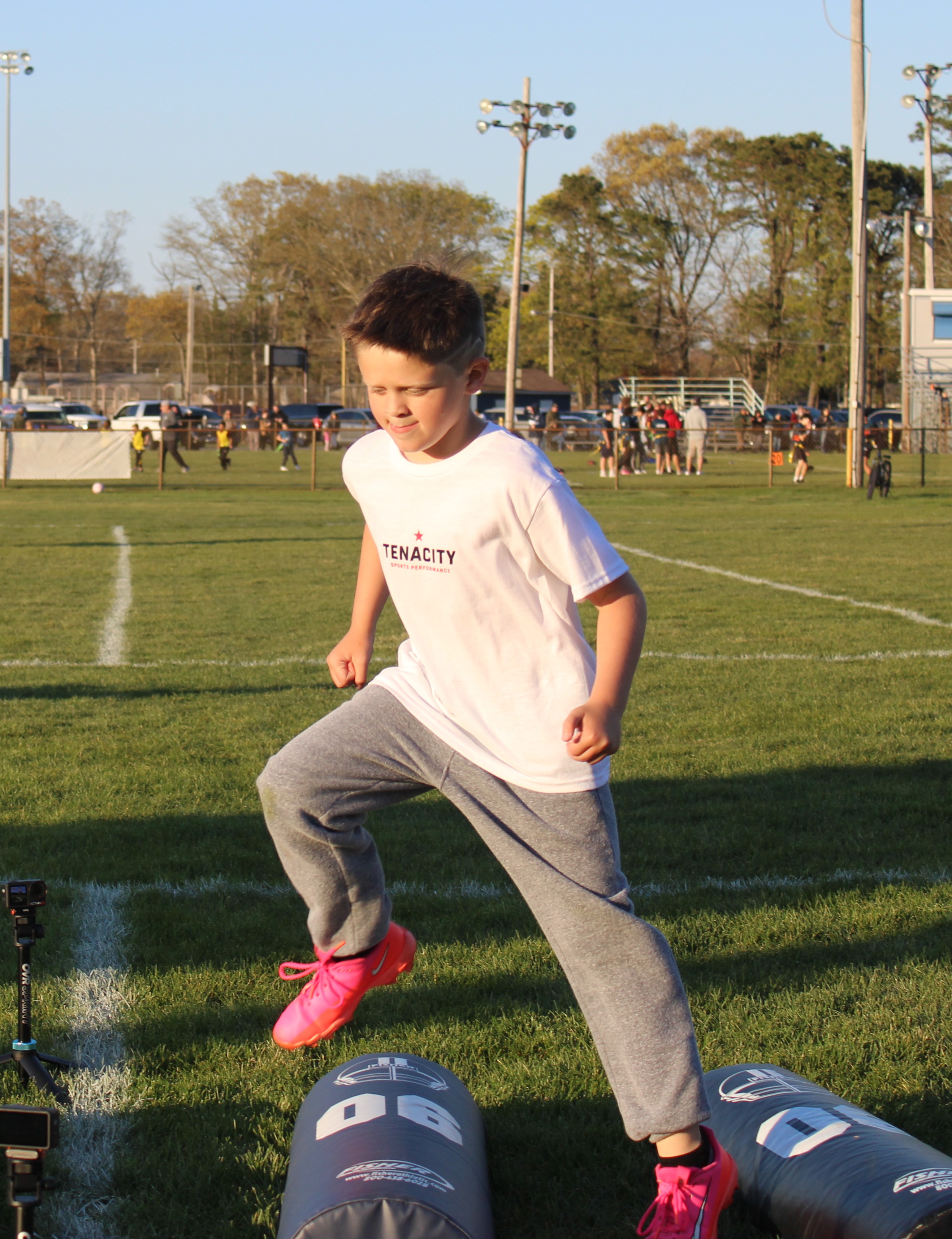 Young Tenacity athlete stepping through agility bags during speed and coordination training