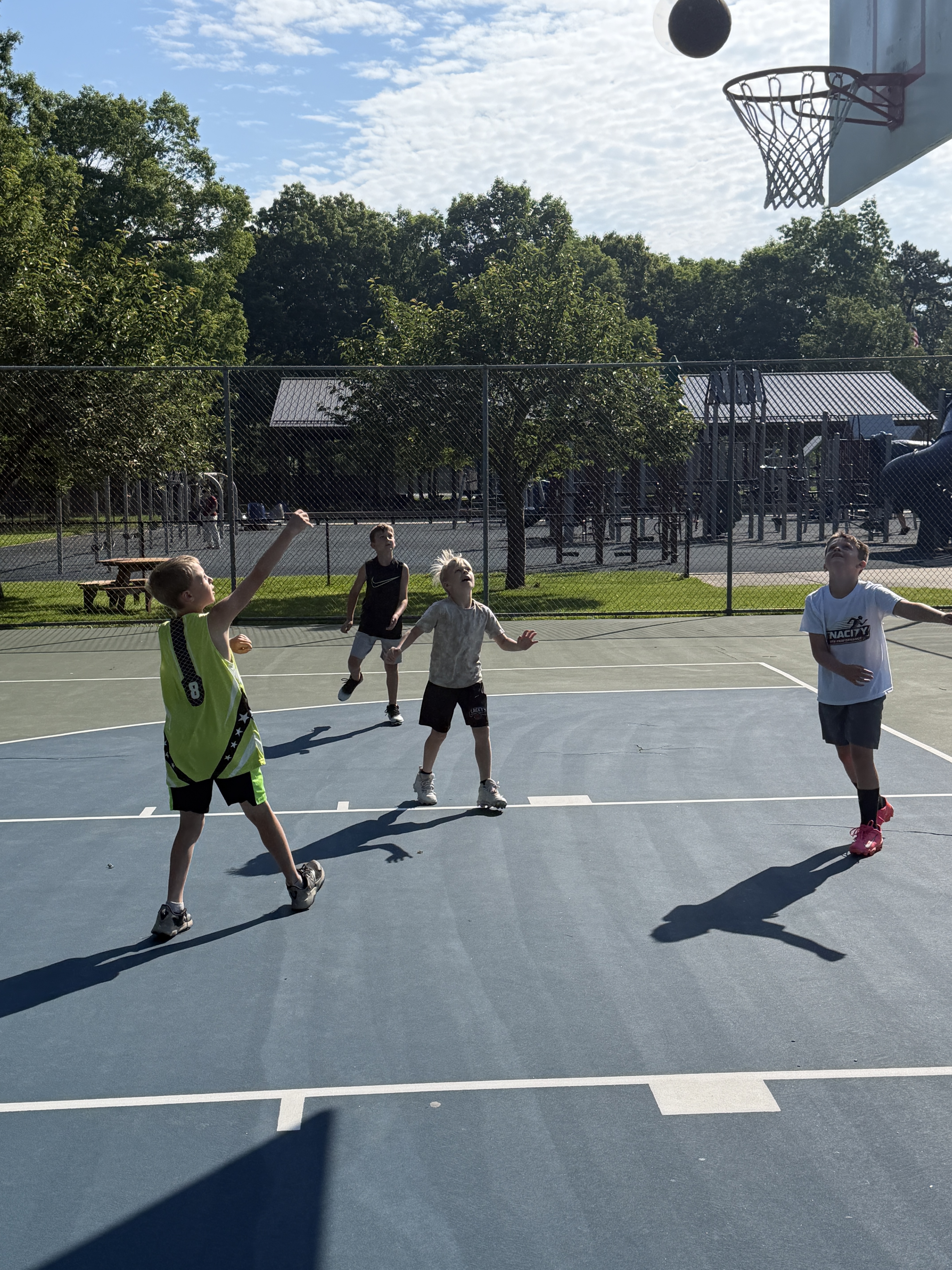 Homeschool students playing basketball outside