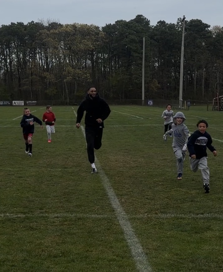 Young athletes running during a Tenacity PE session