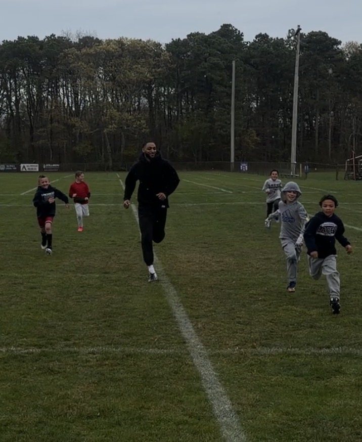 Young Tenacity athletes sprinting during an outdoor movement session