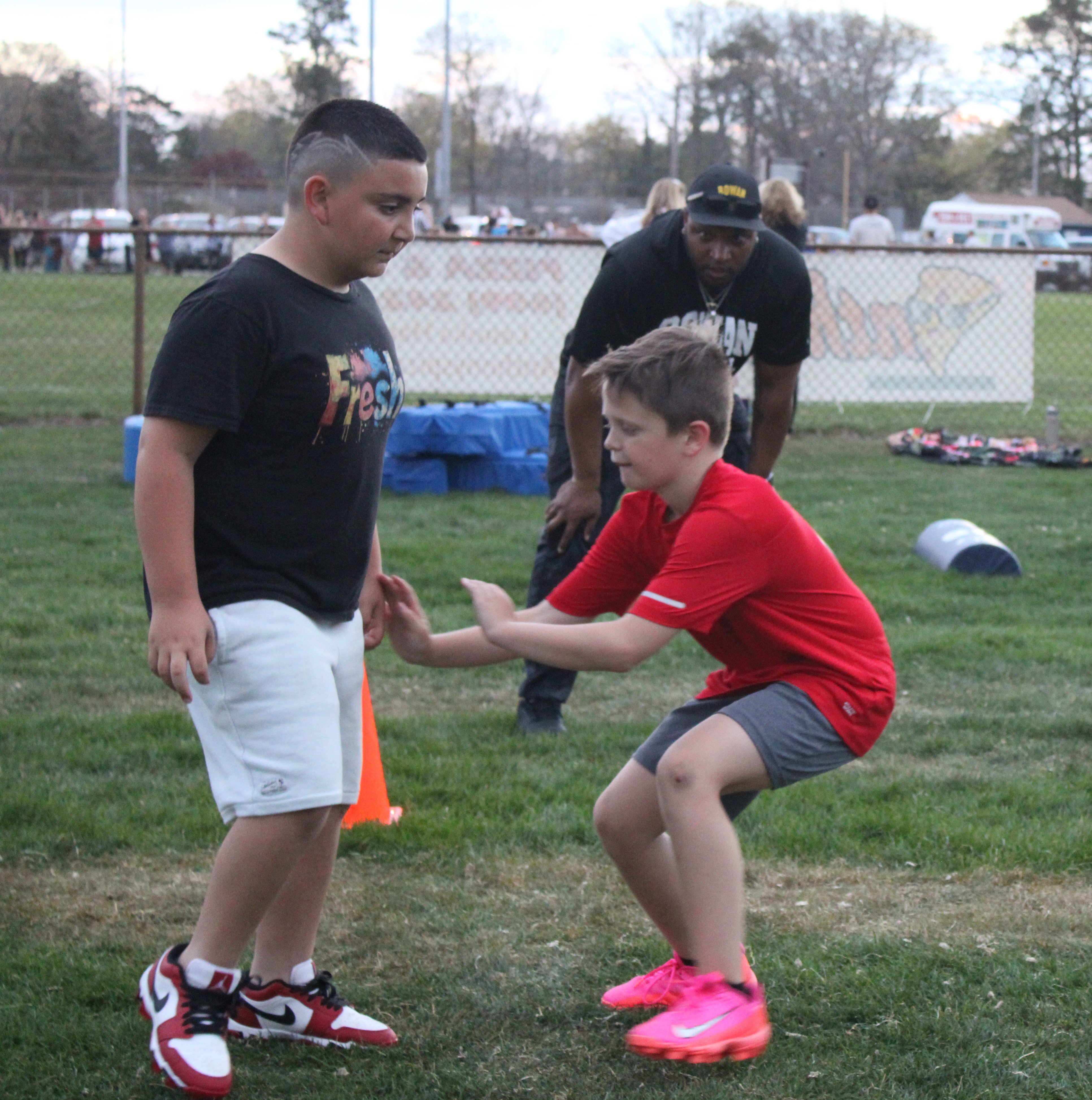 Young football athletes practicing O-line stance and blocking fundamentals